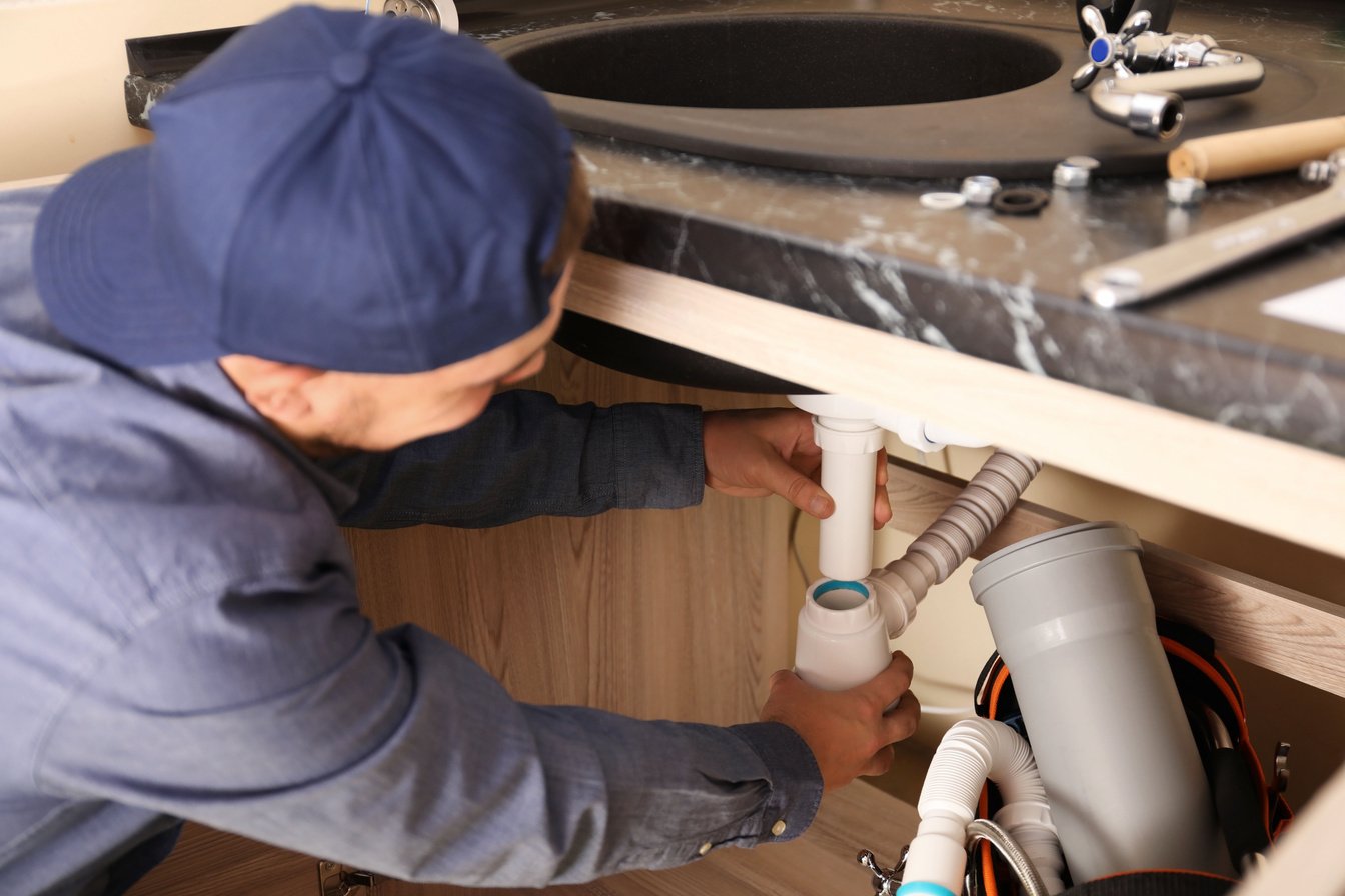 Male Plumber Repairing Sink